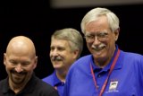 Three Men in Blue Shirts and Glasses