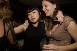 Two Friends Laughing Together at a Nightclub