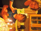Birthday Boy Watches Candles Light Up His Cake