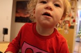 Curious Toddler in Red Shirt at Home