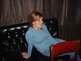 Woman Relaxing on Black Leather Sofa at Bar