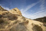 Majestic Rocky Hill amidst the Blue Sky and Clouds