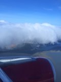 Flying over a Cloudy Water Body