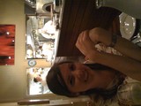 Woman Smiling at Open Kitchen Restaurant Table