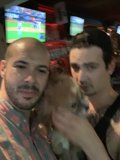 Two Men and a Canine in a City Bar