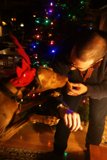 Man and his Canine Companion Pose by Christmas Tree