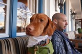 Dog and Owner Relaxing at Outdoor Cafe