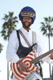 Man with a Turban Strumming His Guitar in Nature