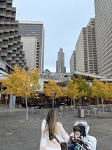 Mother and Child in Modern Urban Plaza