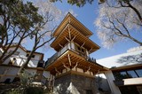 Traditional Japanese Bell Tower Among Frost-Covered Trees
