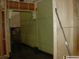 Open Door with Broom in Plywood Room