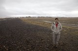 Woman Standing Among Ancient Tufa Spires in Desert