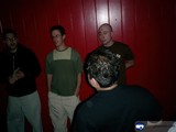 Group of Four Men in a Red Wall Background