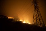 Flames Threaten Power Lines on Hillside