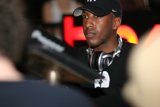 Black Shirted Man Rocks The Cap And Headphones