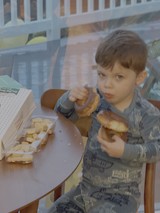 Young Child Enjoying Donuts at Home