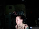 Tattooed woman in front of a speaker