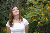 Woman Gazing Upward Among Yellow Wildflowers