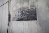 A Plaque on the Architectural Slate Wall with Wires