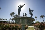 Serenity in Stone: Three Statues and a Fountain in the Garden