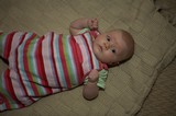 Bright-Eyed Baby Resting on Knit Blanket