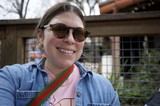 Smiling Portrait at Outdoor Venue in Sunglasses