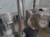 Toddler Drawing on Stainless Steel Refrigerator