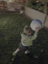 Child Playing with Soccer Ball in Motion