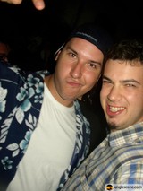 Two Men Strike a Pose in Baseball Hats
