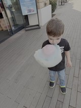 Child Enjoys Cotton Candy on Pedestrian Plaza