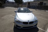 Parked BMW M4 in a Glimmering Parking Lot