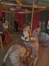Child Riding Carousel Tiger in Motion