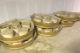 Golden Containers Contrasting with Concrete