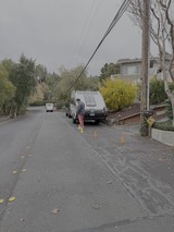 Utility Worker Managing Power Lines on Residential Street