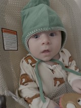 Newborn Baby in Green Hat at Hospital