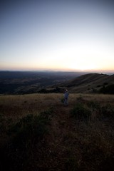 Child Gazing at Twilight Over Rolling California Hills