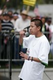 Hugo Ayala addresses the crowds Caption: Hugo Ayala holds a microphone and addresses a sea of faces during the 2006 student protest.
