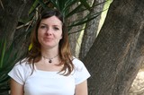 Portrait of Young Woman Among Palm Trees