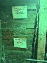 Drug Warning Signs in Green-Lit Mine Alley