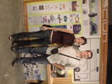 Couple Poses Next to Wooden Sign