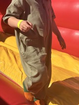 Child in Gray Hoodie on Colorful Playground Equipment