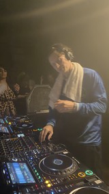 DJ Performance in Atmospheric Club Setting