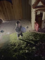 Child Crouching by Mossy Courtyard Fountain