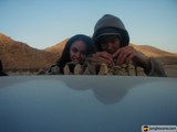 Sitting on the Hood of a Car in the Desert