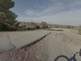 Cracked Asphalt Road in Rural Setting