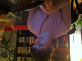 Woman Captivated by Tablet Glow in Dim Library