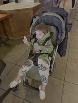Young Child Relaxing in Stroller Indoors