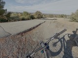 Cyclist's View of Cracked Desert Road