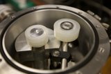 Two White Spoke Wheels in Metal Container