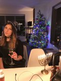 Holiday Cheers in Front of the Sparkling Tree